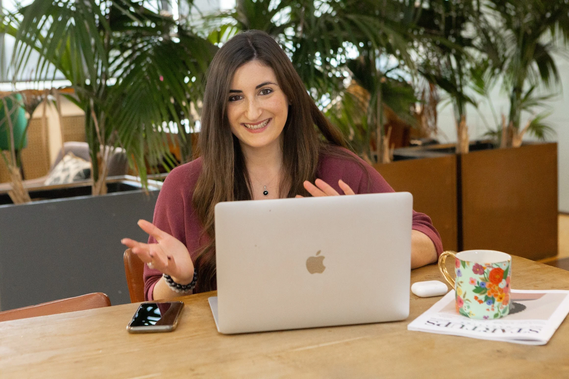 Charlotte Simmons at her laptop, working with a client
